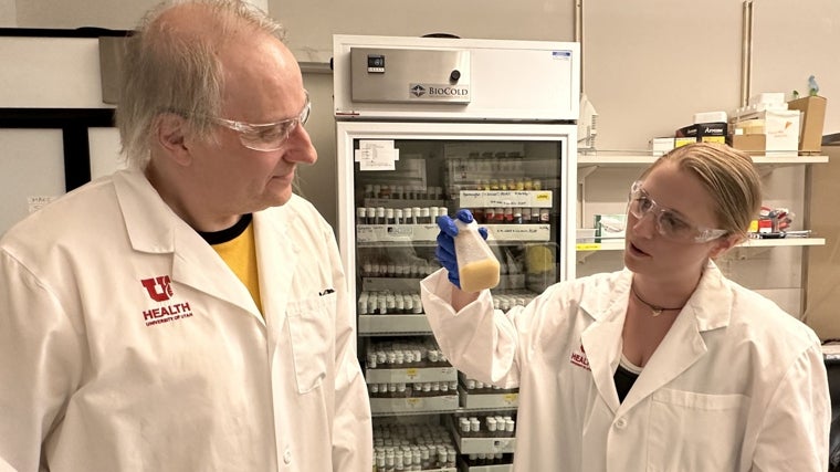 Adrian Rothenfluh (izquierda) y Pearl Cummins-Beebee (derecha; también autora del estudio) analizan una botella con moscas de la fruta en el laboratorio